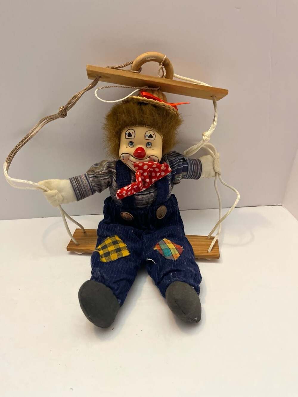 Vintage Porcelain Clown Marionette Puppet Hanging On A Wooden Swing